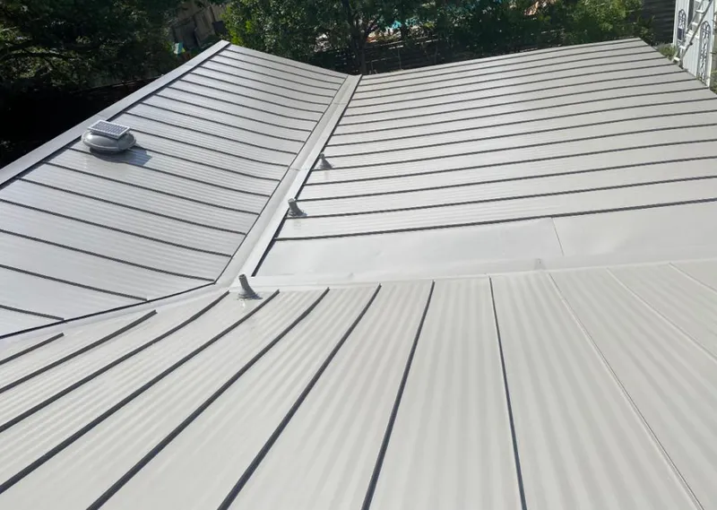 Solar attic fan installed on a metal roof for Roof Ventilation in Parkland